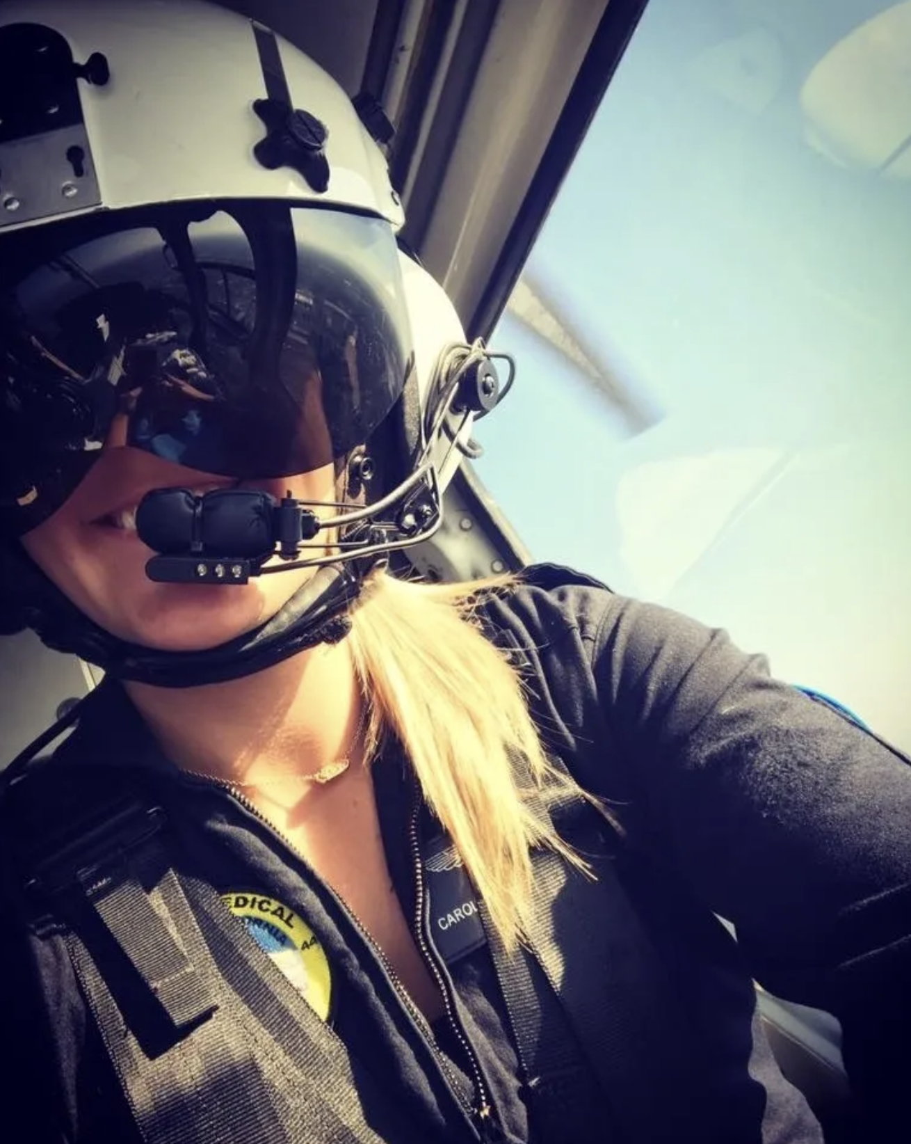 C. Covey in flight helmet inside helicopter