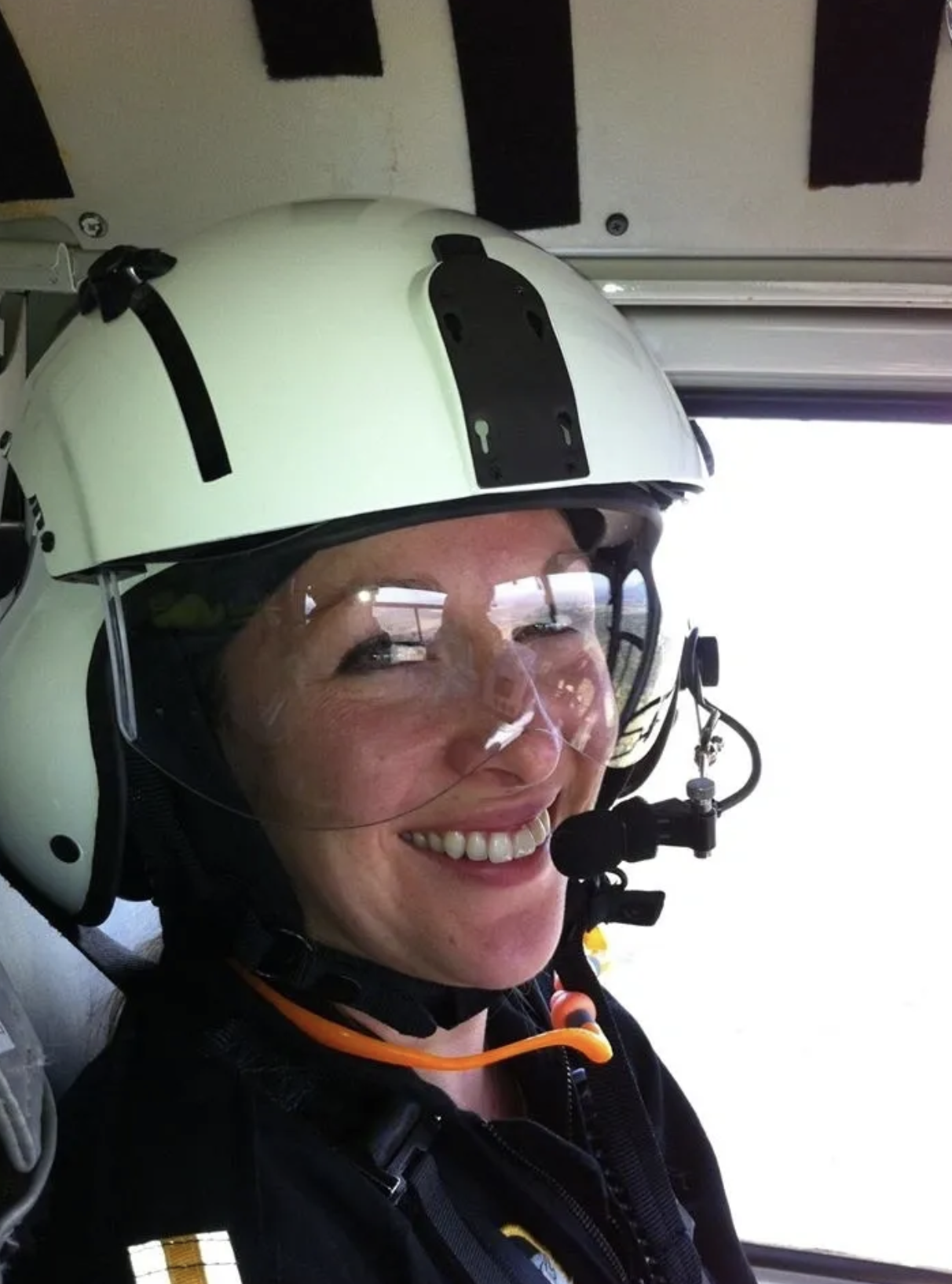 J. Land in flight helmet inside helicopter