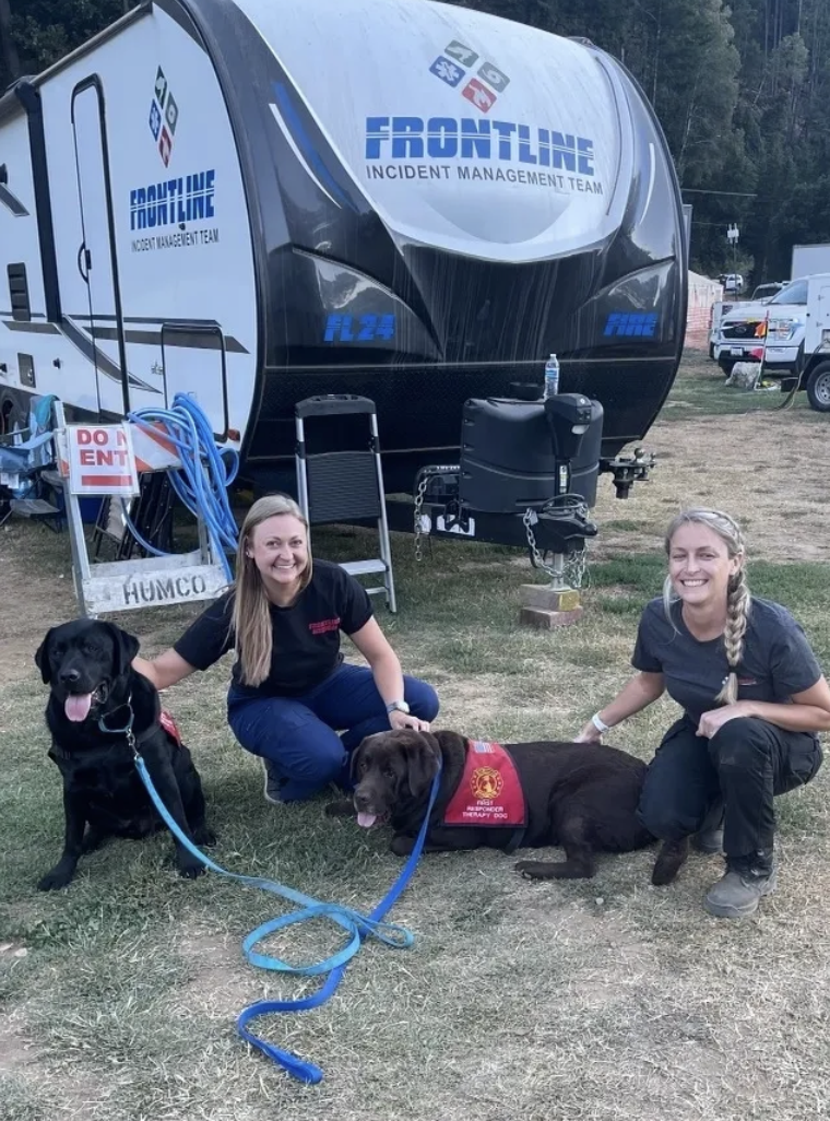 Frontline Medical crew walking therapy dogs at base camp