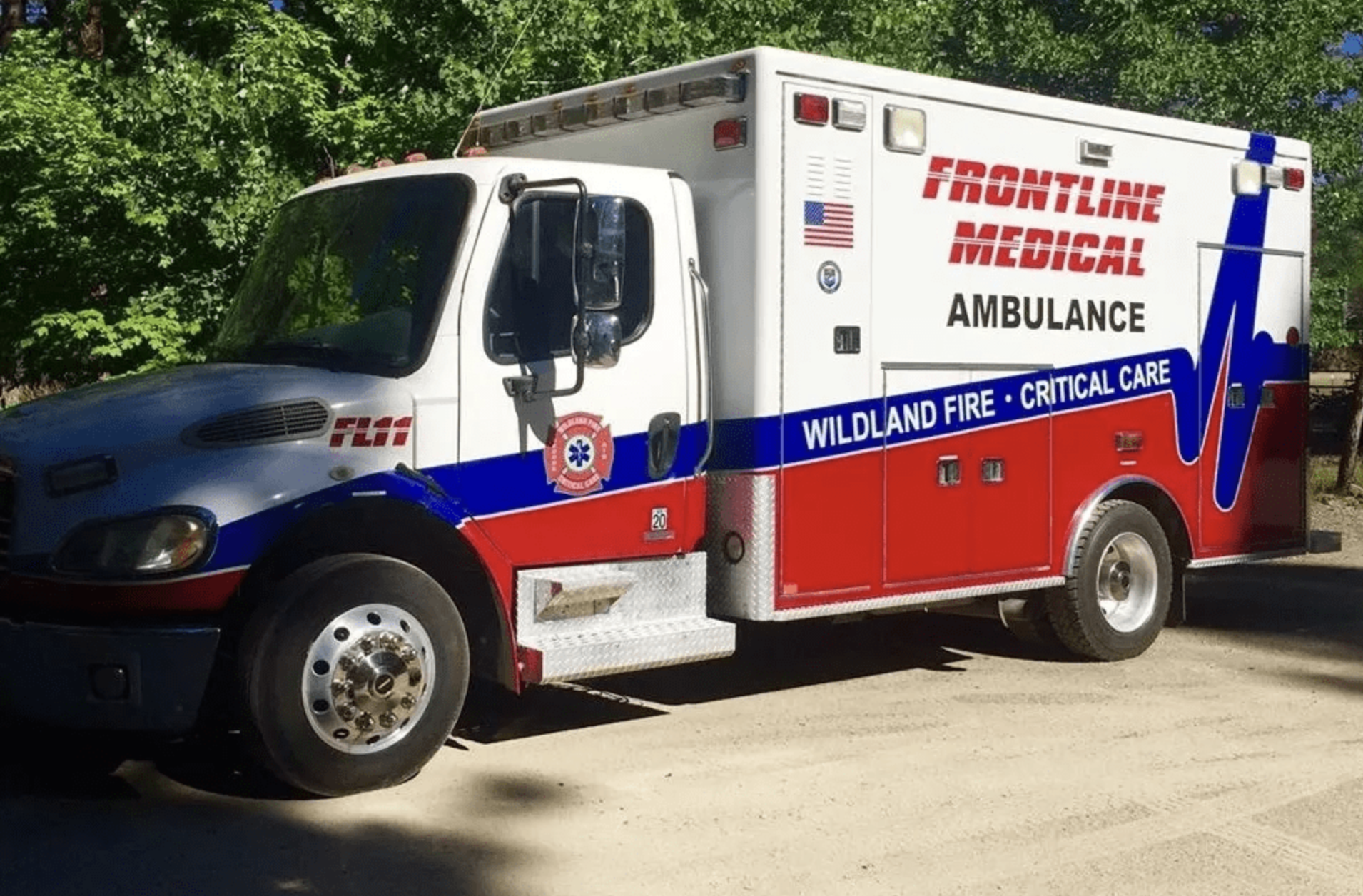 Red and white ALS ambulance parked on road